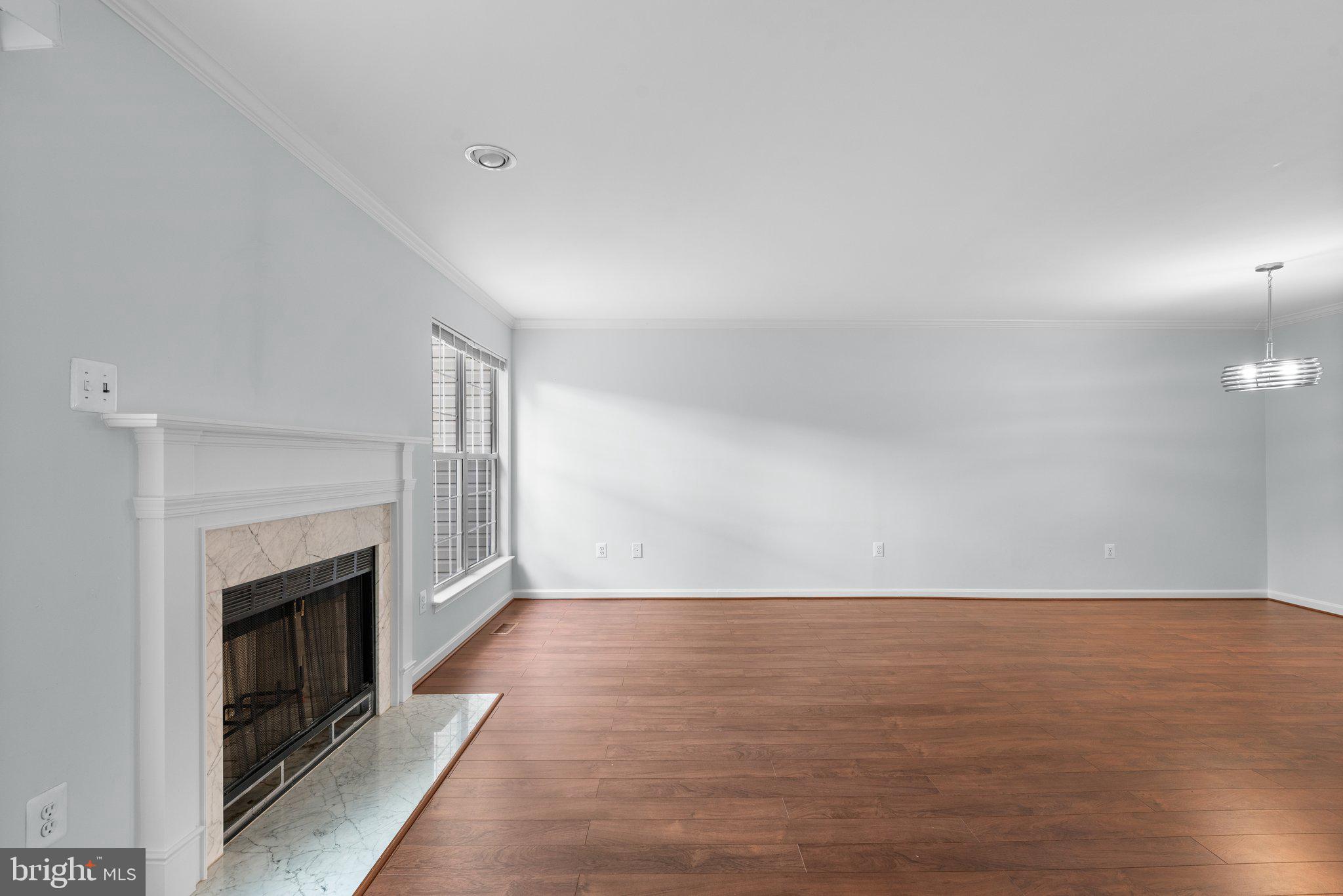 2204 Commissary Circle Odenton, MD 21113 - Photo 9 of 49 a view of an empty room with wooden floor fireplace and a window