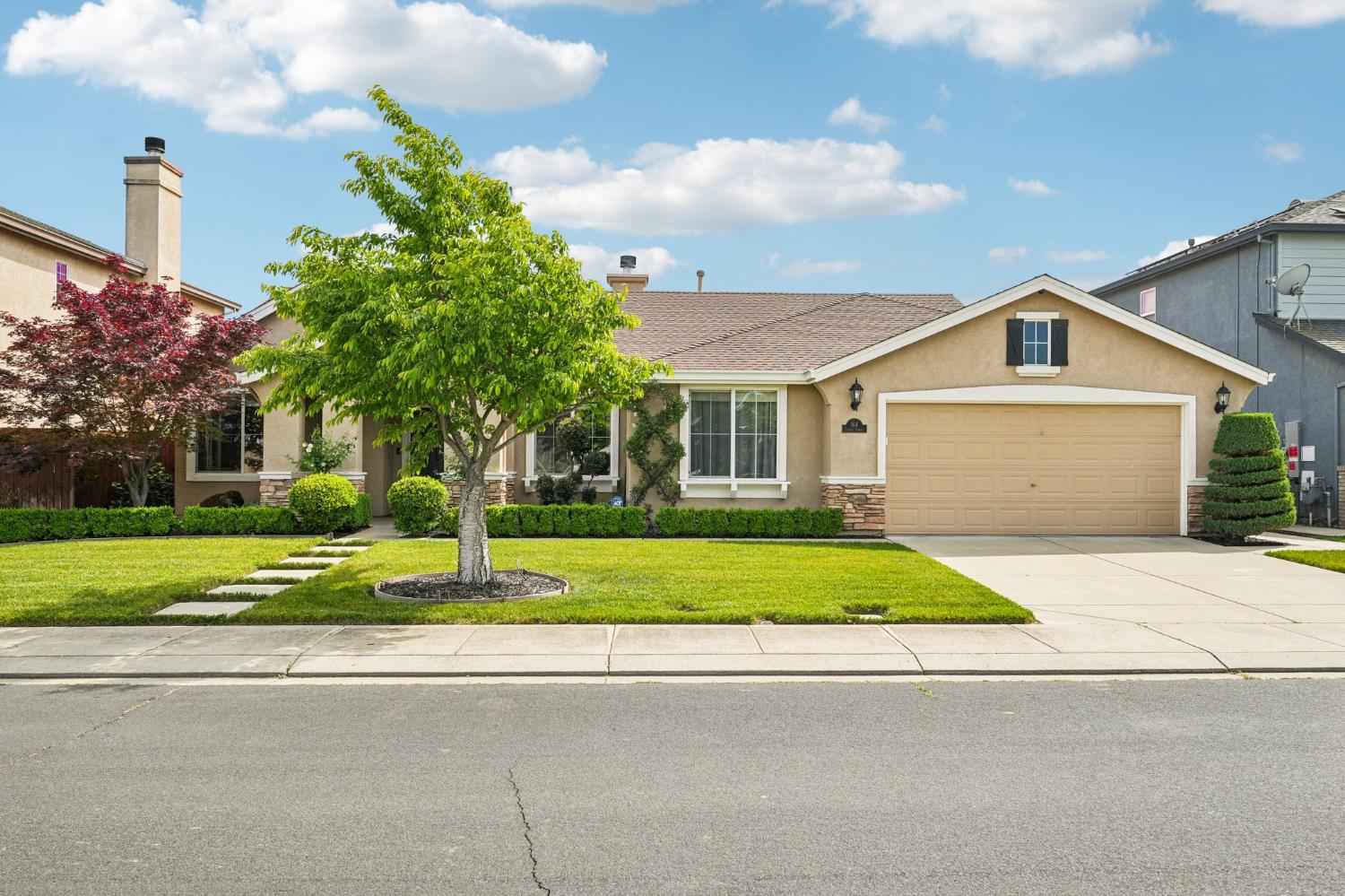 a front view of a house with a yard and garage