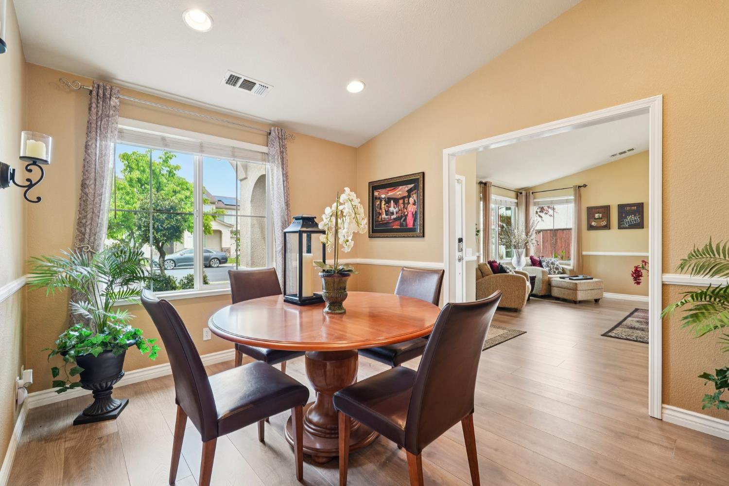 164 Legacy Street Manteca, CA 95337 - Photo 11 of 33 a view of a dining room with furniture window and wooden floor