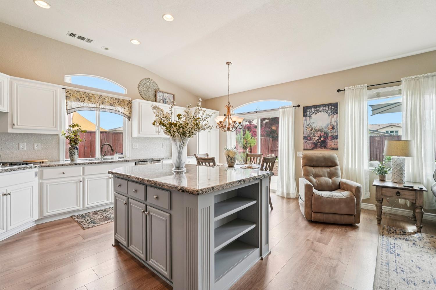 164 Legacy Street Manteca, CA 95337 - Photo 13 of 33 a kitchen with granite countertop a sink cabinets and wooden floor