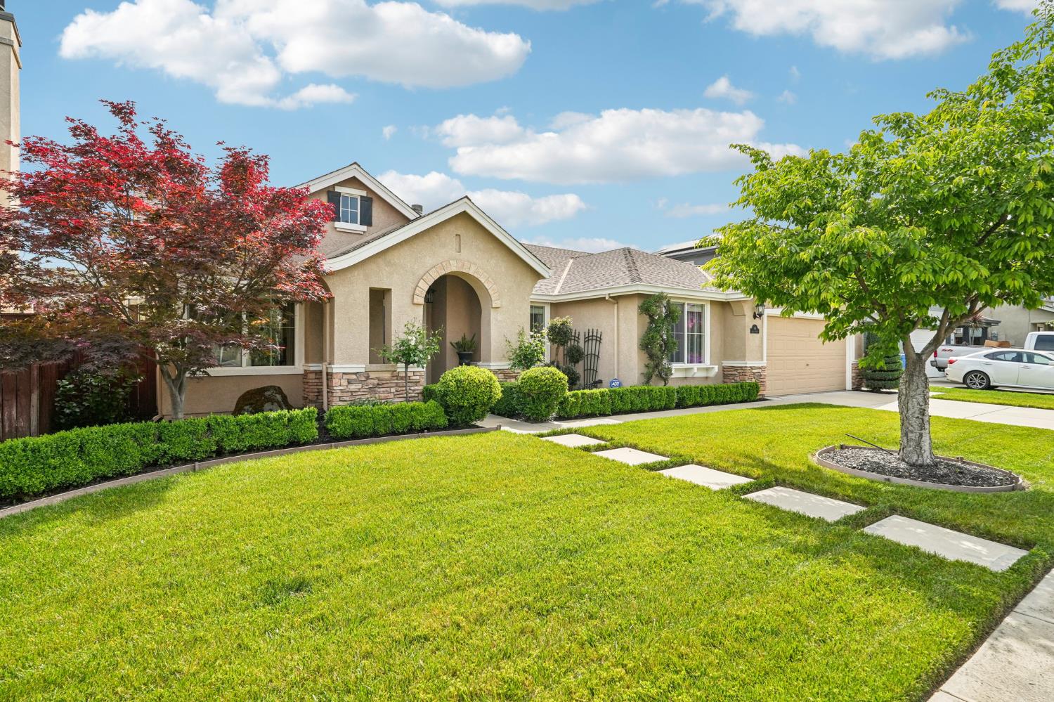 164 Legacy Street Manteca, CA 95337 - Photo 2 of 33 a front view of a house with a yard