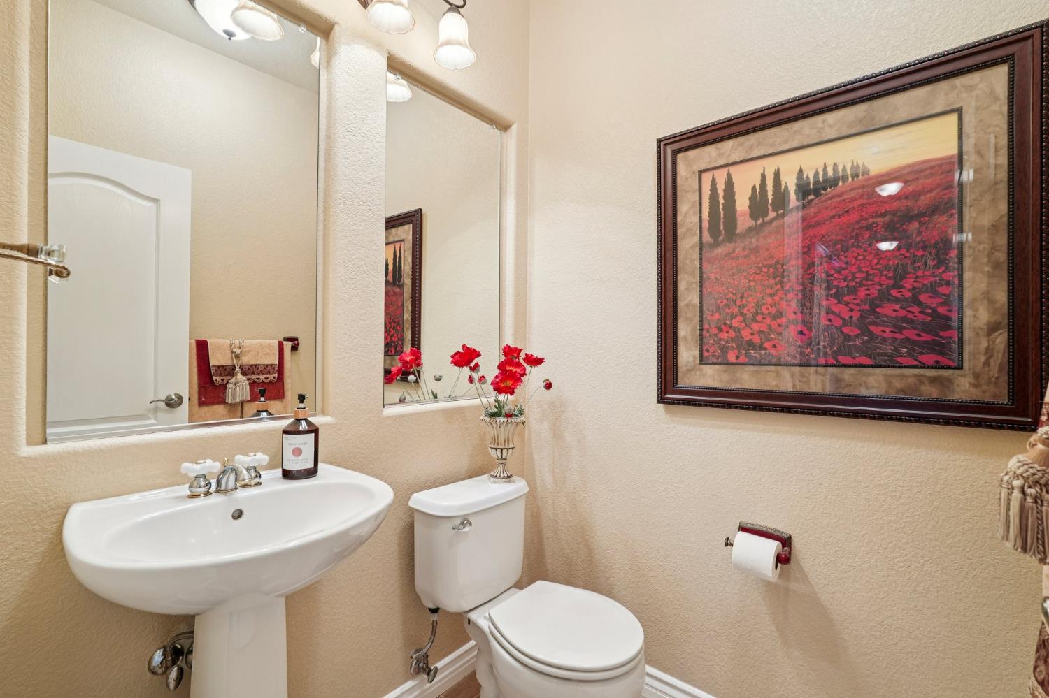164 Legacy Street Manteca, CA 95337 - Photo 23 of 33 a bathroom with a toilet sink and mirror