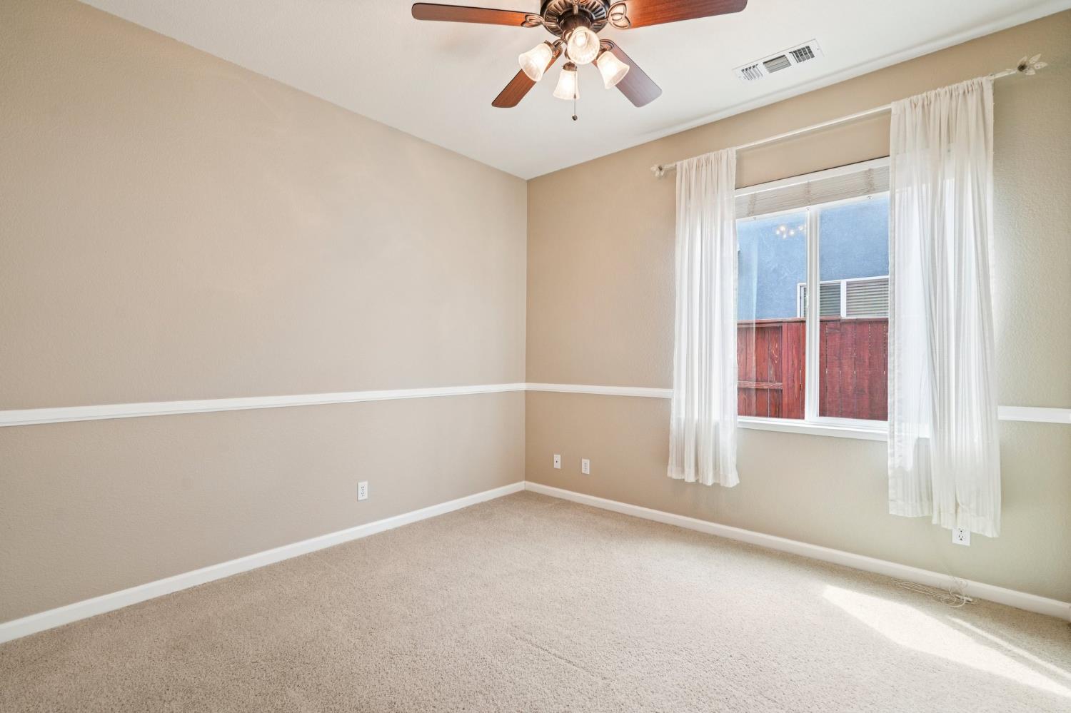 164 Legacy Street Manteca, CA 95337 - Photo 25 of 33 an empty room with a window and a fan