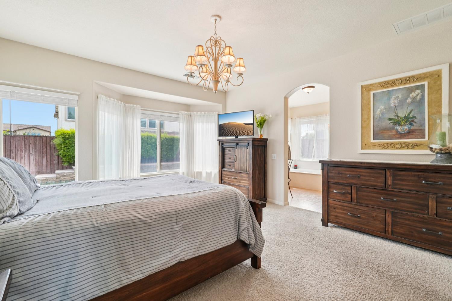 164 Legacy Street Manteca, CA 95337 - Photo 27 of 33 a bedroom with a bed and a dresser