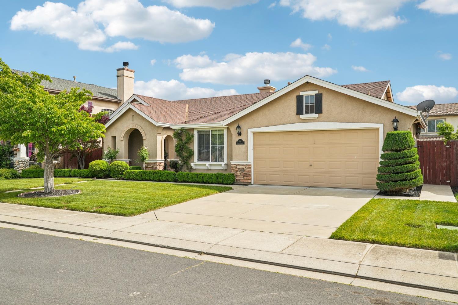 164 Legacy Street Manteca, CA 95337 - Photo 3 of 33 a front view of a house with a yard and garage