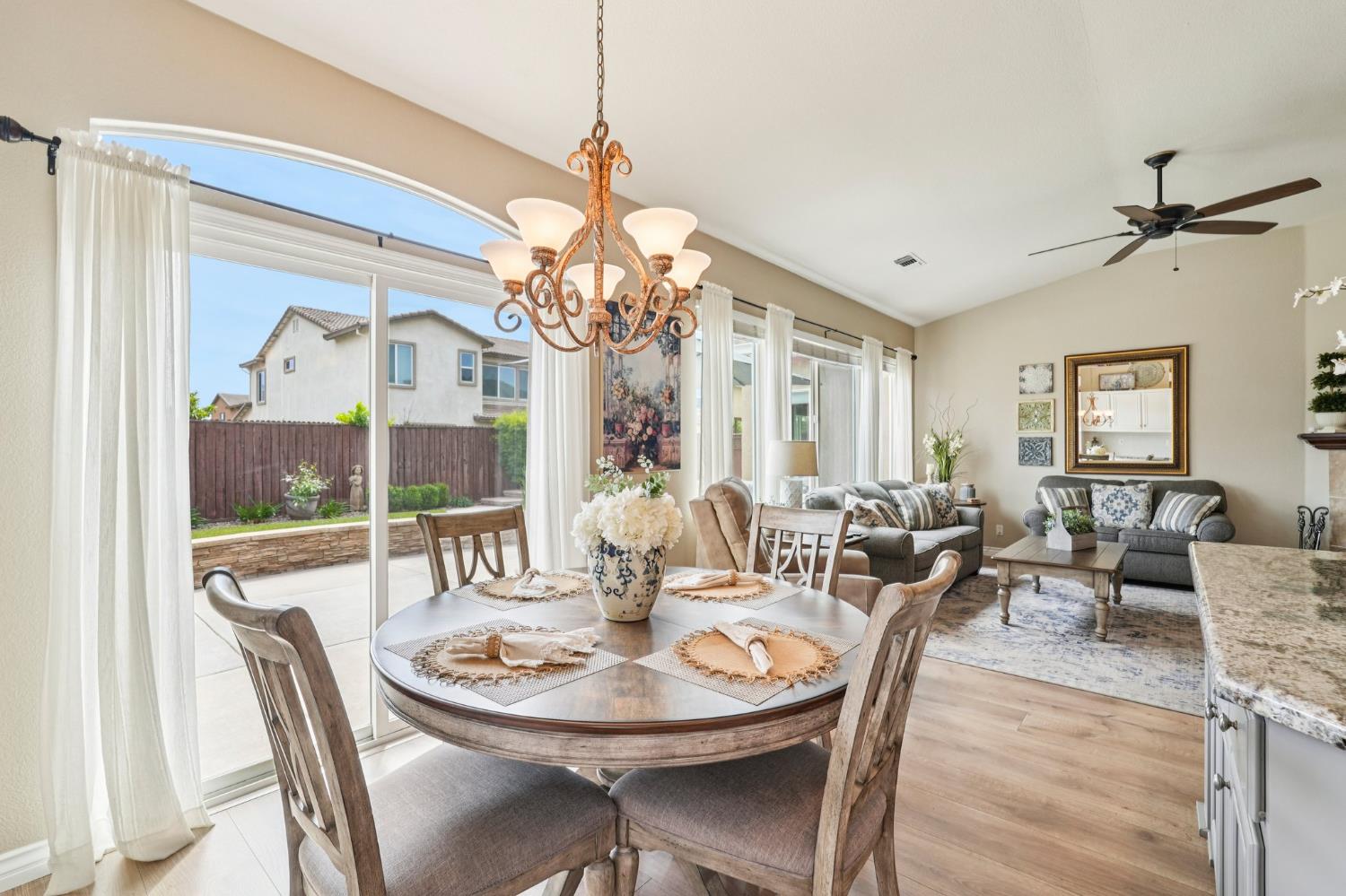 164 Legacy Street Manteca, CA 95337 - Photo 9 of 33 a view of a dining room with furniture a chandelier and wooden floor
