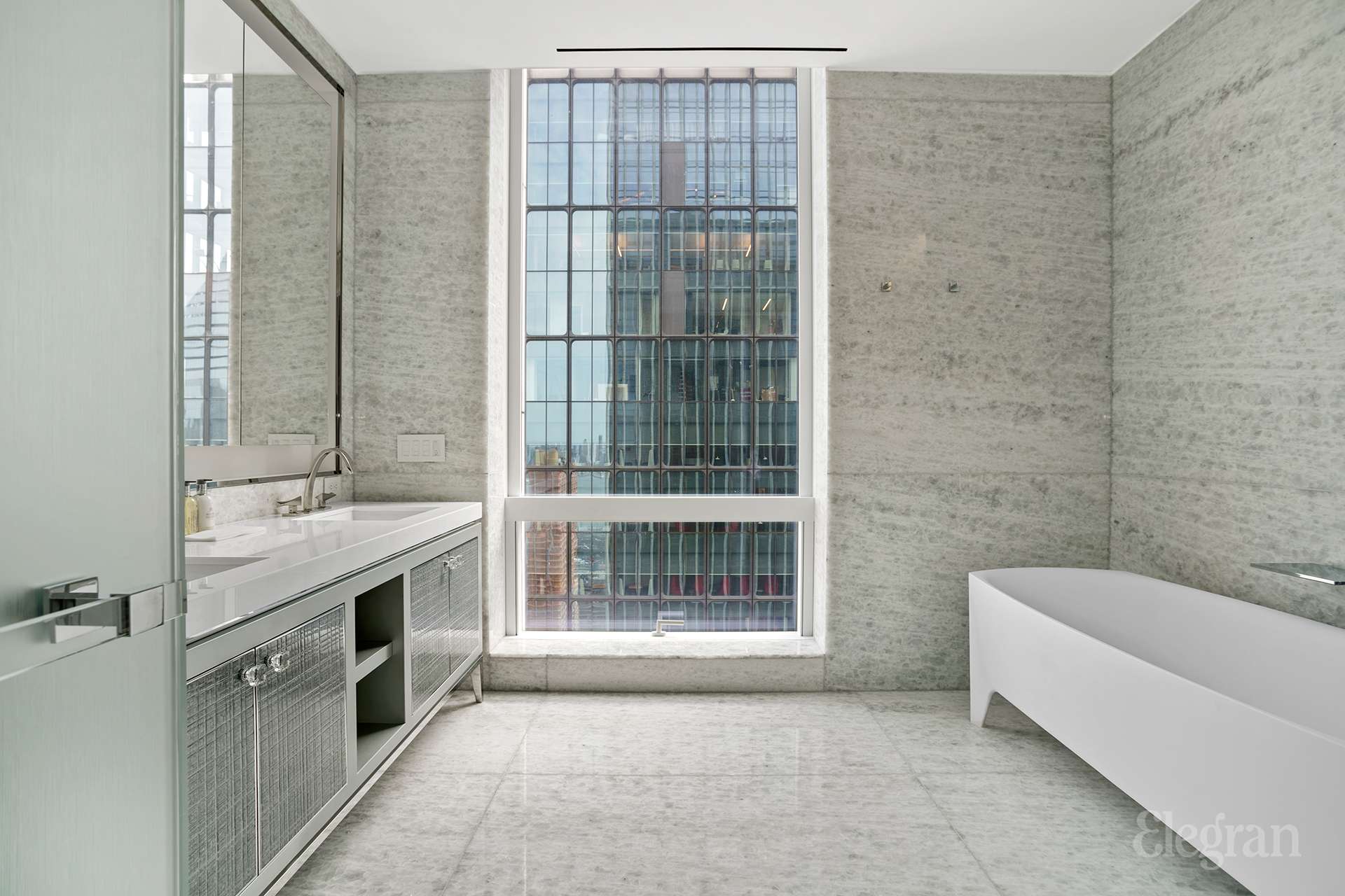 35 Hudson Yards, Unit 6802 Manhattan, NY 10001 - Photo 3 of 22 a bathroom with a tub sink shower and mirror