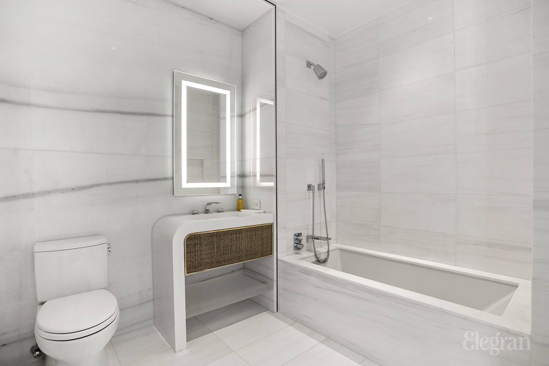 35 Hudson Yards, Unit 6802 Manhattan, NY 10001 - Photo 5 of 22 a bathroom with a toilet a sink and bathtub