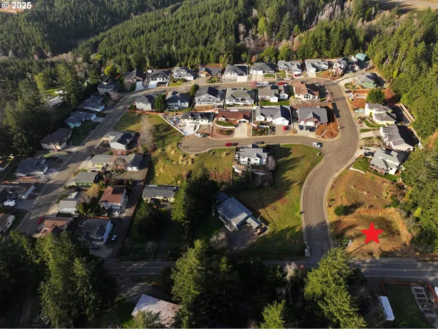 an aerial view of a house with a swimming pool and outdoor seating