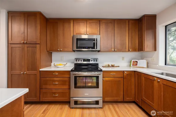 a kitchen with stainless steel appliances a refrigerator and a stove top oven
