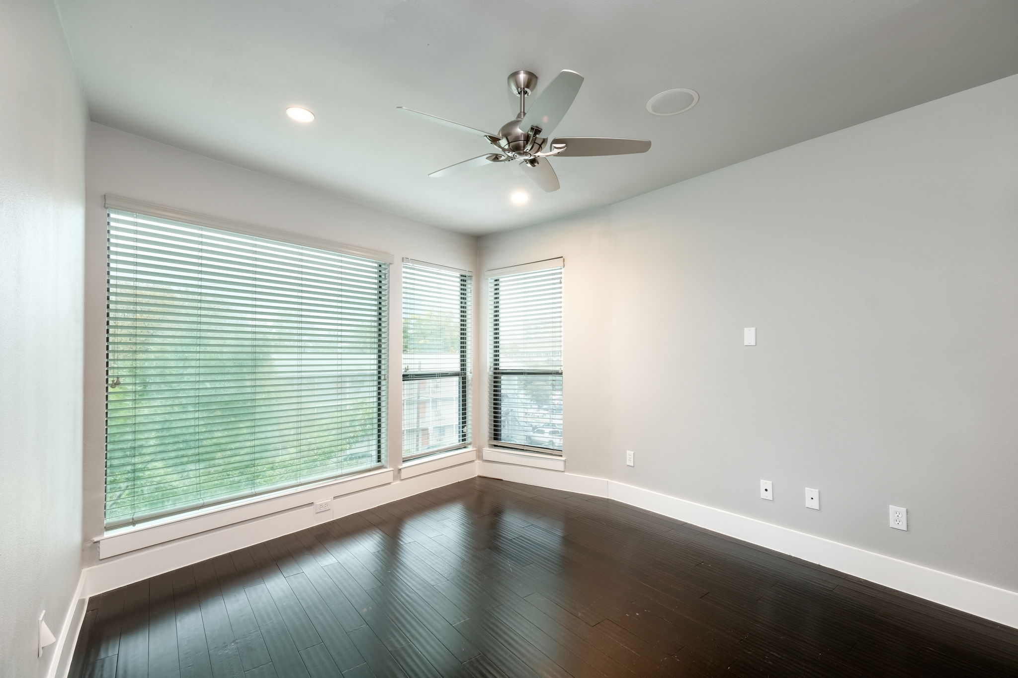 3000 Speedway Street, Unit E Austin, TX 78705 - Photo 6 of 16 Rich hardwood floors and expansive windows define this versatile room, offering ample natural illumination.