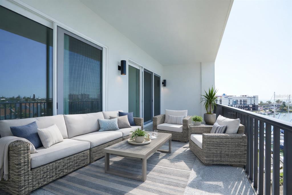 400 150th Avenue, Unit 501 Madeira Beach, FL 33708 - Photo 28 of 76 a balcony with furniture and a couch