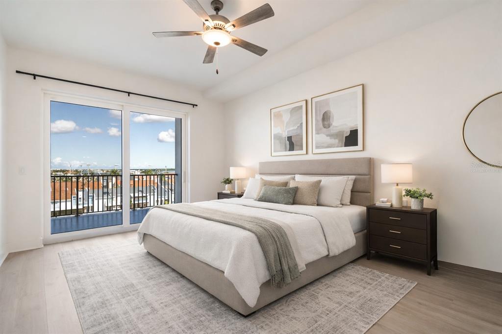 400 150th Avenue, Unit 501 Madeira Beach, FL 33708 - Photo 31 of 76 a bedroom with a large bed and a chandelier