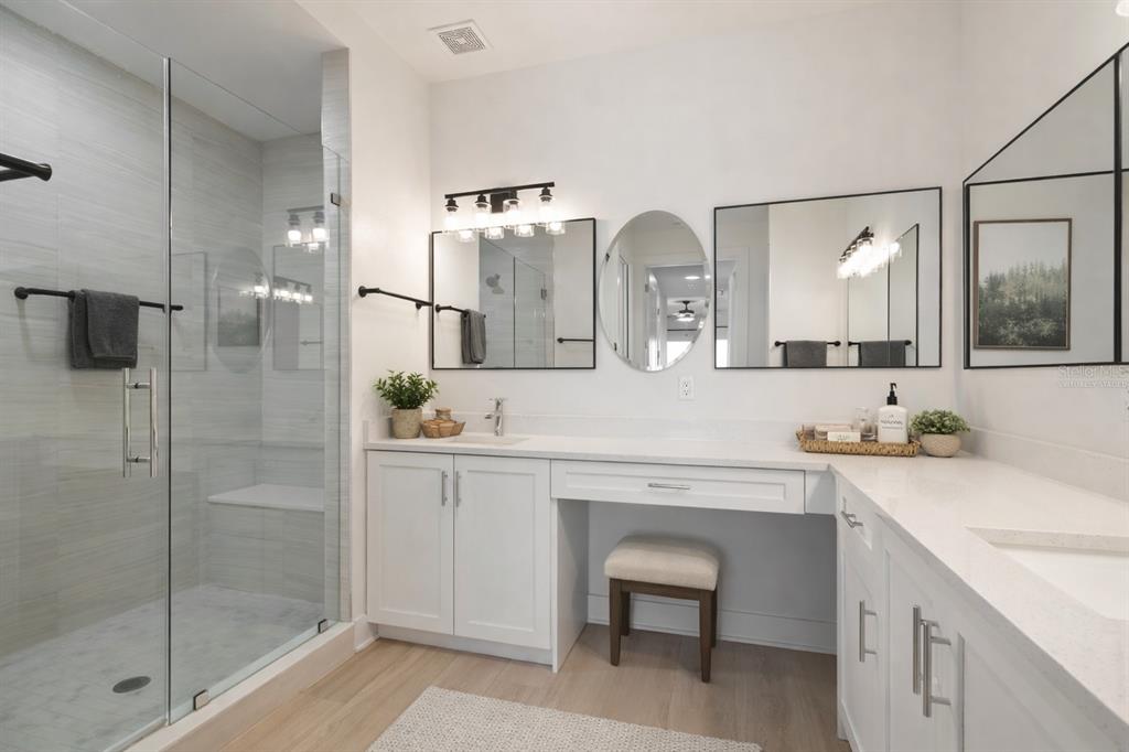 400 150th Avenue, Unit 501 Madeira Beach, FL 33708 - Photo 32 of 76 a spacious bathroom with a shower a sink and mirror