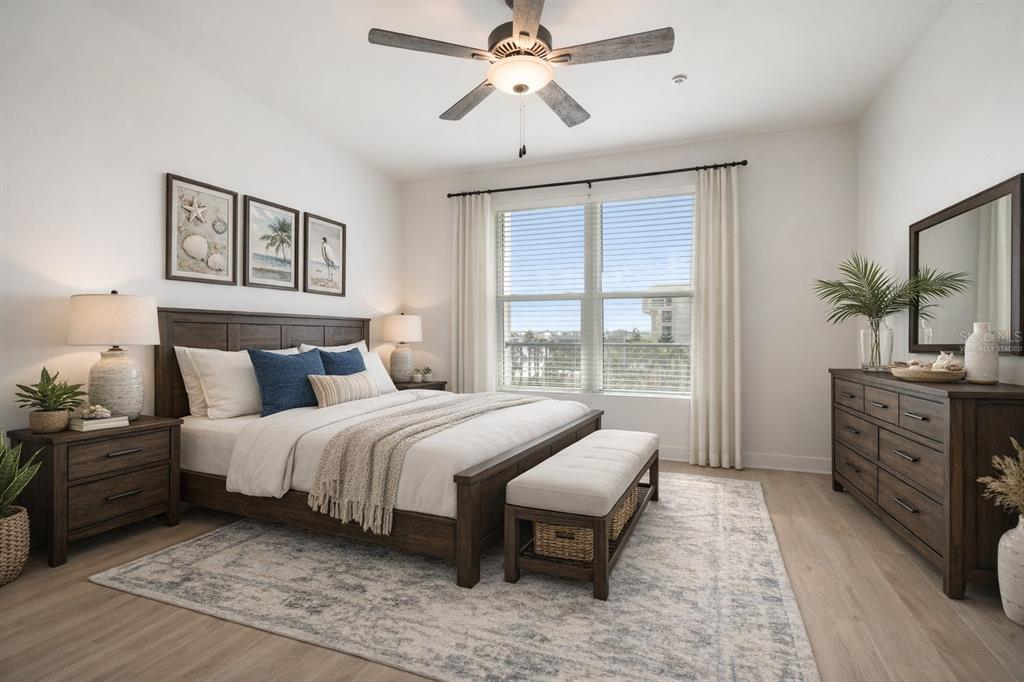 400 150th Avenue, Unit 501 Madeira Beach, FL 33708 - Photo 33 of 76 a bedroom with a large bed and a chandelier fan