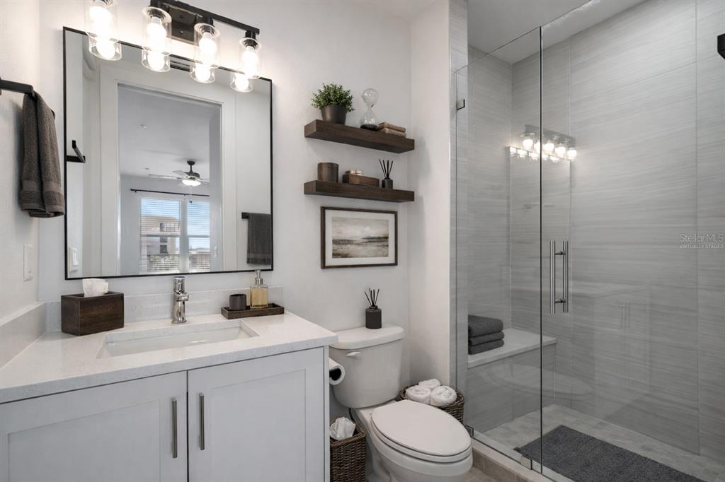 400 150th Avenue, Unit 501 Madeira Beach, FL 33708 - Photo 34 of 76 a bathroom with a sink vanity granite toilet and a shower