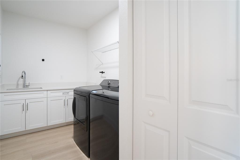 400 150th Avenue, Unit 501 Madeira Beach, FL 33708 - Photo 37 of 76 a utility room with cabinets washer and dryer