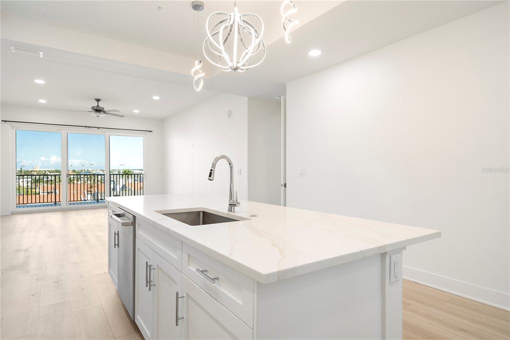 400 150th Avenue, Unit 501 Madeira Beach, FL 33708 - Photo 41 of 76 a kitchen with a sink a counter top space and a window