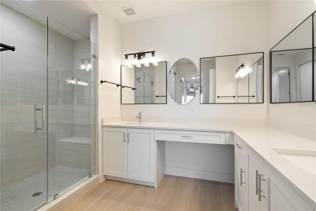 400 150th Avenue, Unit 501 Madeira Beach, FL 33708 - Photo 45 of 76 a bathroom with a double vanity sink mirror and double