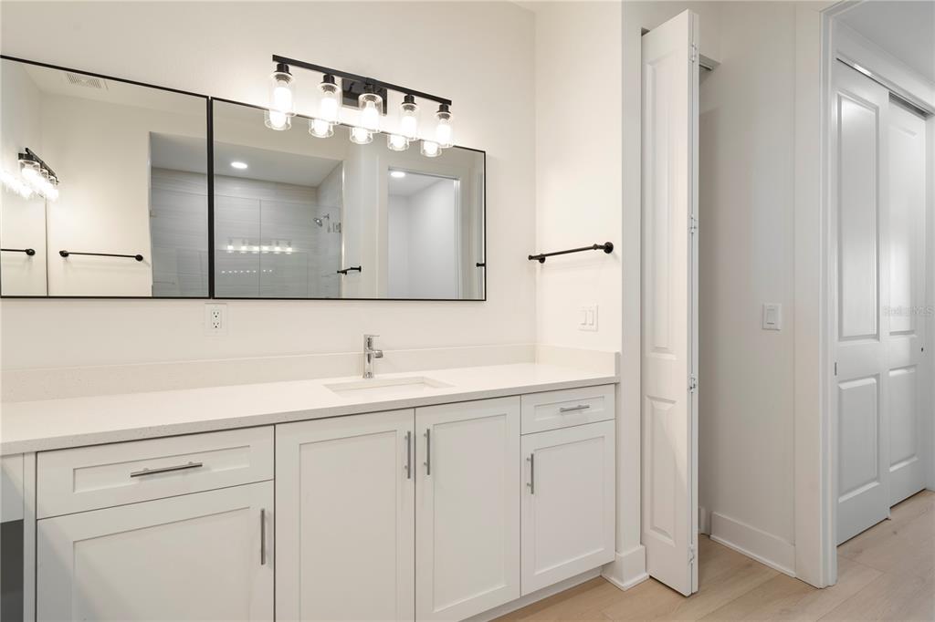 400 150th Avenue, Unit 501 Madeira Beach, FL 33708 - Photo 46 of 76 a bathroom with a sink and a mirror