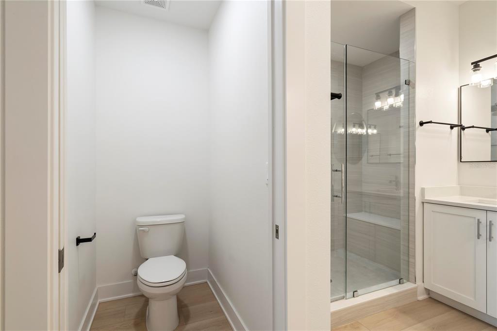 400 150th Avenue, Unit 501 Madeira Beach, FL 33708 - Photo 47 of 76 a a bathroom view of a toilet and a glass door