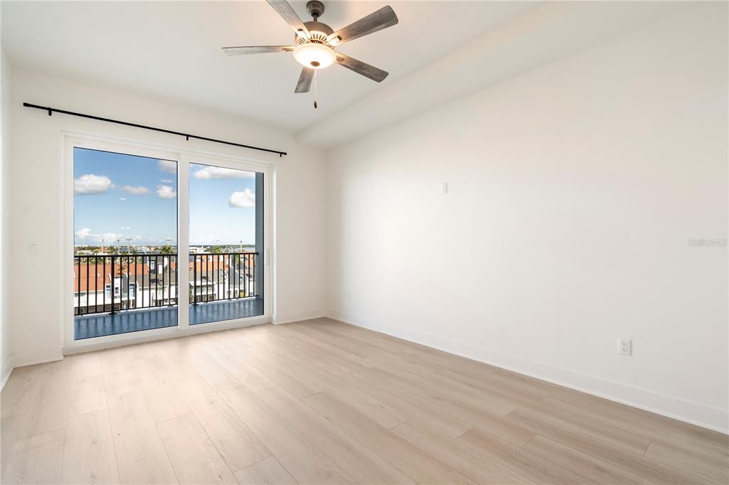 400 150th Avenue, Unit 501 Madeira Beach, FL 33708 - Photo 57 of 76 an empty room with wooden floor and windows