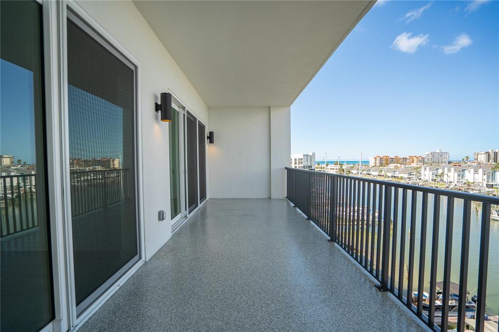 400 150th Avenue, Unit 501 Madeira Beach, FL 33708 - Photo 63 of 76 a view of a hallway with wooden floor