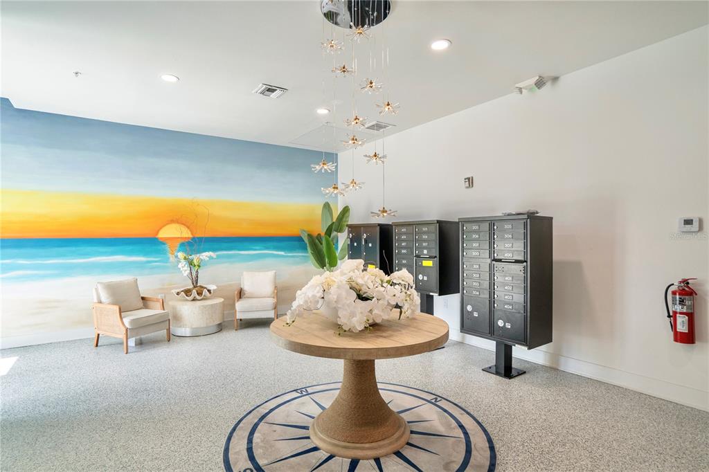 400 150th Avenue, Unit 501 Madeira Beach, FL 33708 - Photo 69 of 76 a living room with furniture and a chandelier