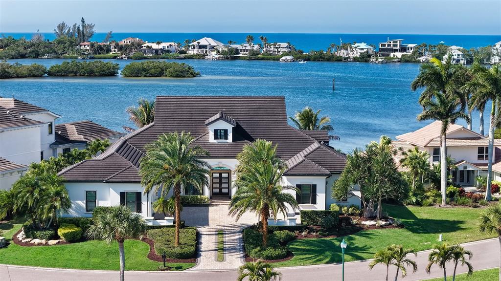 313 Lookout Point Drive Osprey, FL 34229 - Photo 11 of 100 a front view of a house with a garden