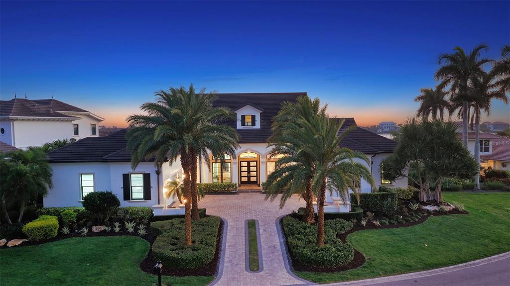 313 Lookout Point Drive Osprey, FL 34229 - Photo 2 of 100 a view of a palm trees in front of a house