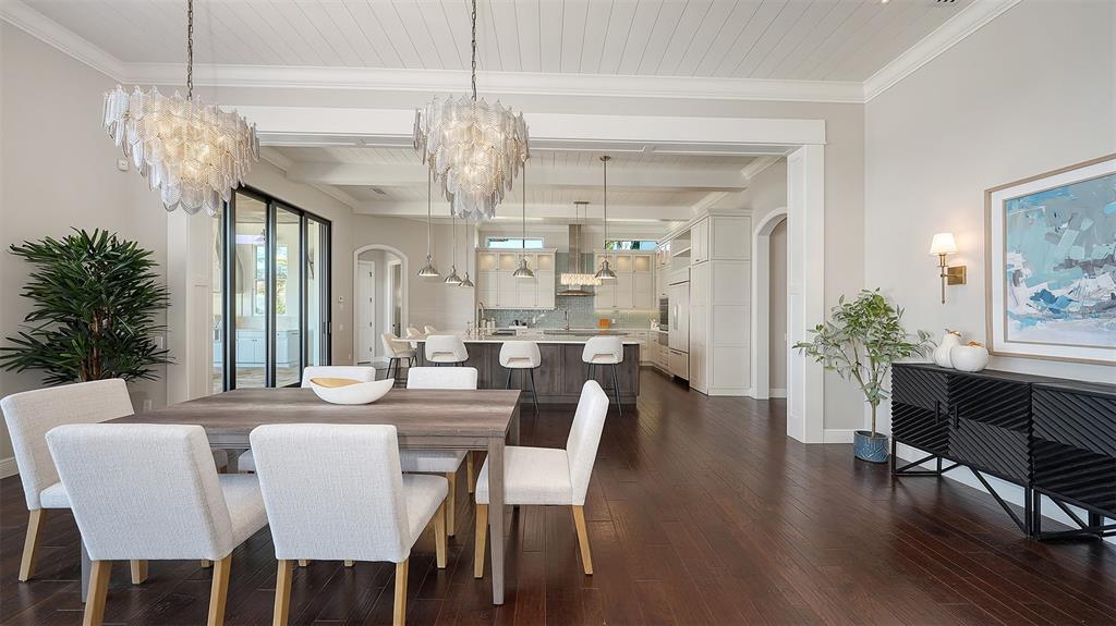 313 Lookout Point Drive Osprey, FL 34229 - Photo 41 of 100 a view of a dining room with furniture a chandelier and wooden floor