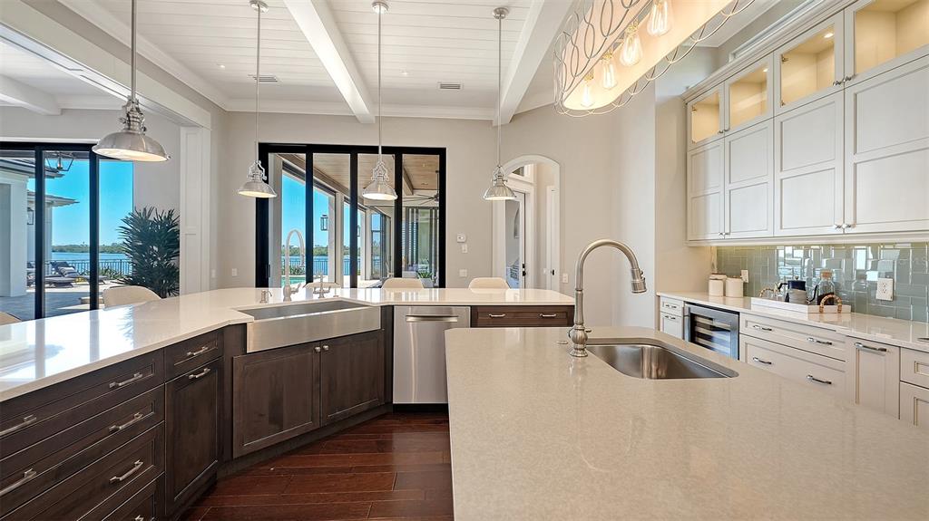 313 Lookout Point Drive Osprey, FL 34229 - Photo 50 of 100 a kitchen with stainless steel appliances granite countertop a sink a stove and a refrigerator