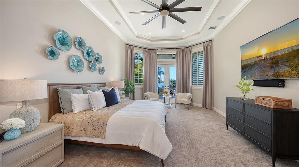 313 Lookout Point Drive Osprey, FL 34229 - Photo 54 of 100 a spacious bedroom with a bed and a flat screen tv
