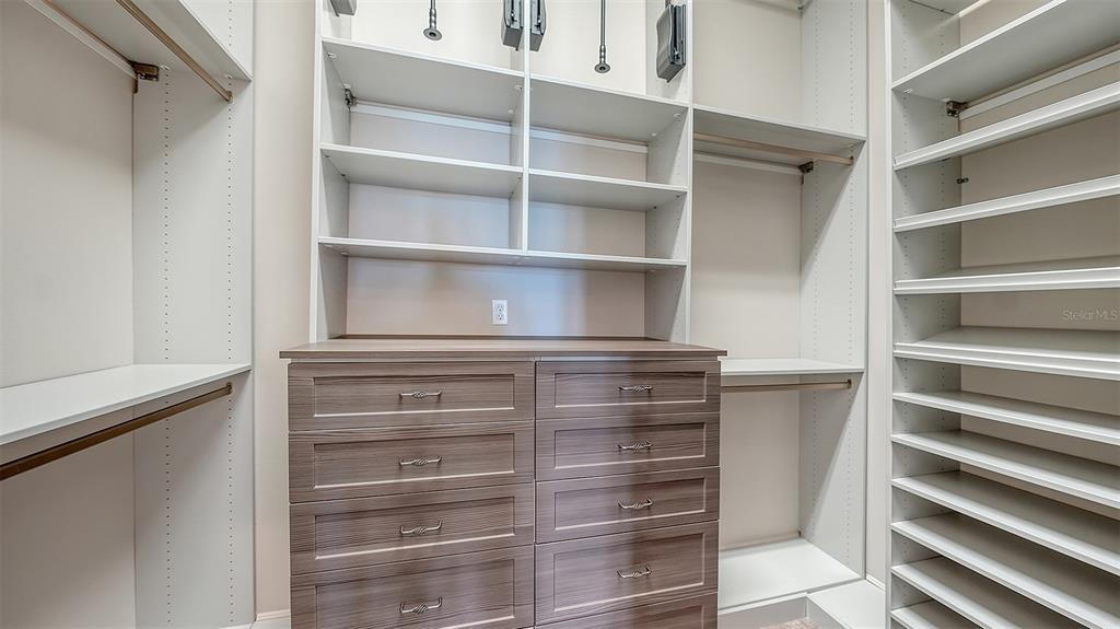 313 Lookout Point Drive Osprey, FL 34229 - Photo 59 of 100 a view of walk in closet with empty racks
