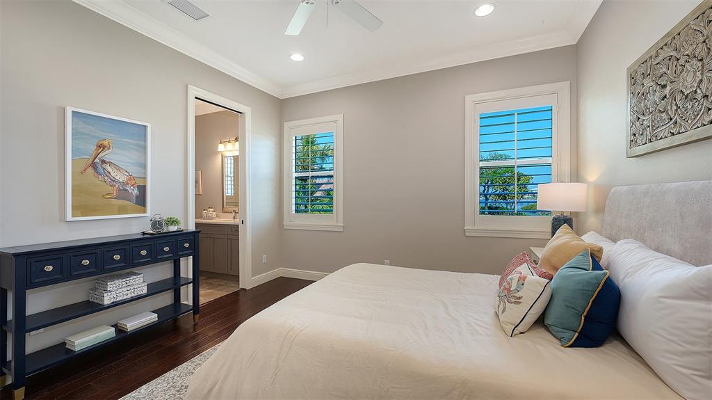 313 Lookout Point Drive Osprey, FL 34229 - Photo 71 of 100 a bedroom with a bed and wooden floor