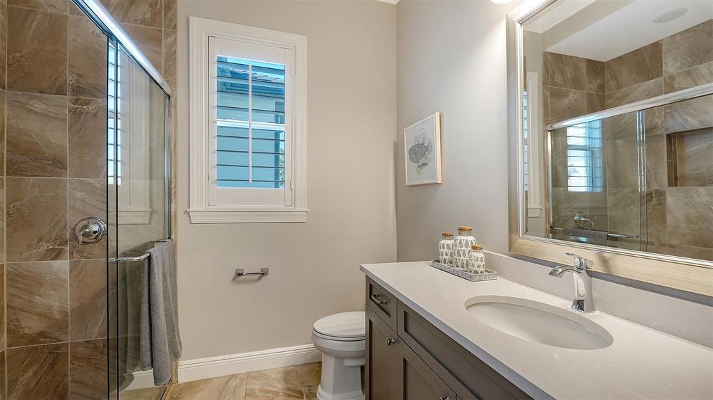 313 Lookout Point Drive Osprey, FL 34229 - Photo 72 of 100 a bathroom with a sink toilet and shower