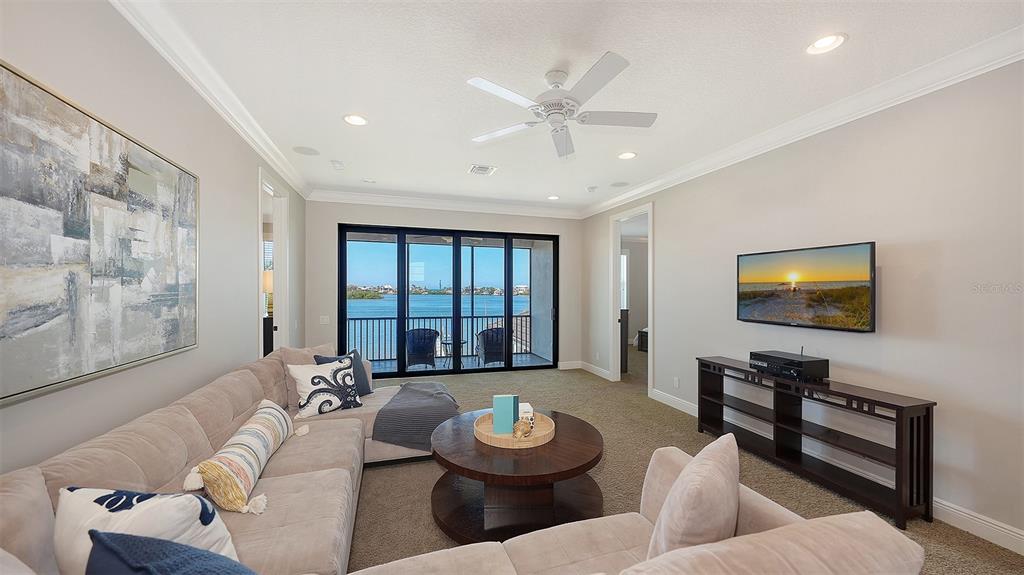 313 Lookout Point Drive Osprey, FL 34229 - Photo 75 of 100 a living room with furniture and a flat screen tv