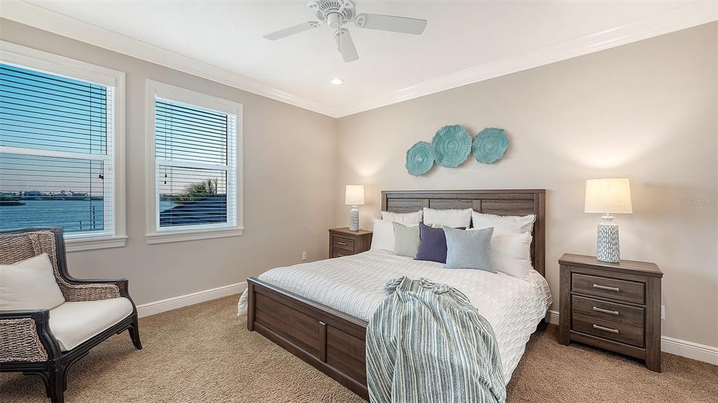 313 Lookout Point Drive Osprey, FL 34229 - Photo 84 of 100 a bedroom with a bed and a couch