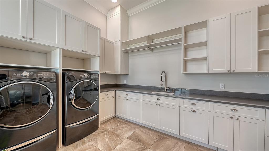 313 Lookout Point Drive Osprey, FL 34229 - Photo 92 of 100 a utility room with sink dryer and washer