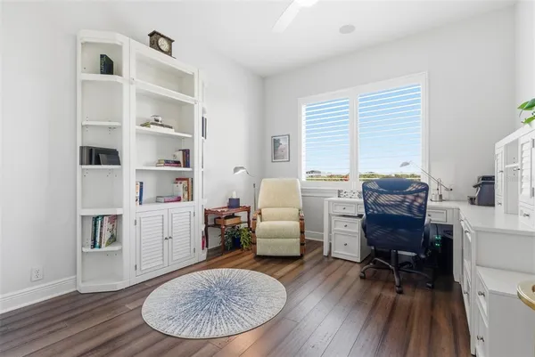 a dining room with furniture a floor to ceiling window and a table