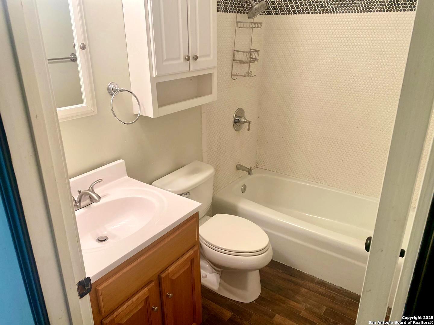 5142 Village Court San Antonio, TX 78218 - Photo 11 of 14 a white toilet sitting next to a bath tub