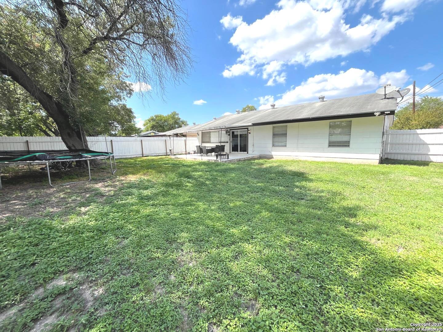 5142 Village Court San Antonio, TX 78218 - Photo 14 of 14 a backyard of a house with table and chairs