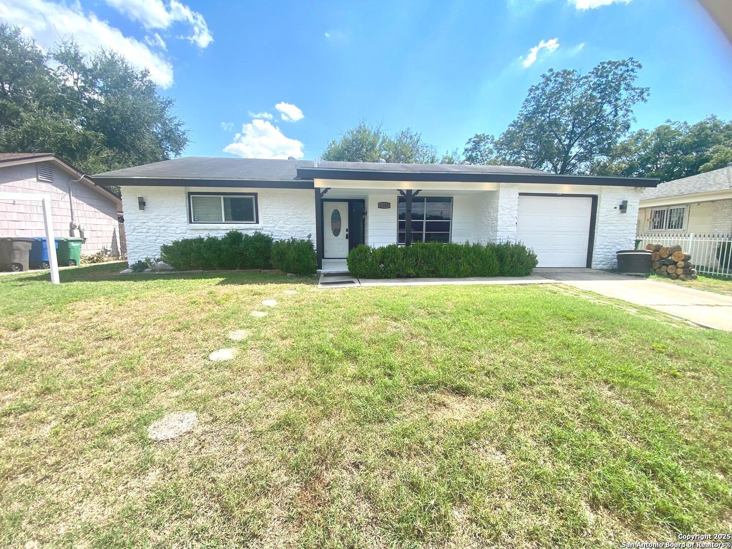 5142 Village Court San Antonio, TX 78218 - Photo 2 of 14 a front view of a house with a yard and garage
