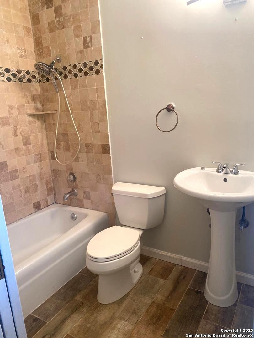 5142 Village Court San Antonio, TX 78218 - Photo 10 of 14 a bathroom with a sink toilet and shower