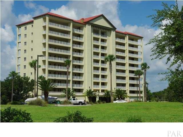 a front view of a building with a yard