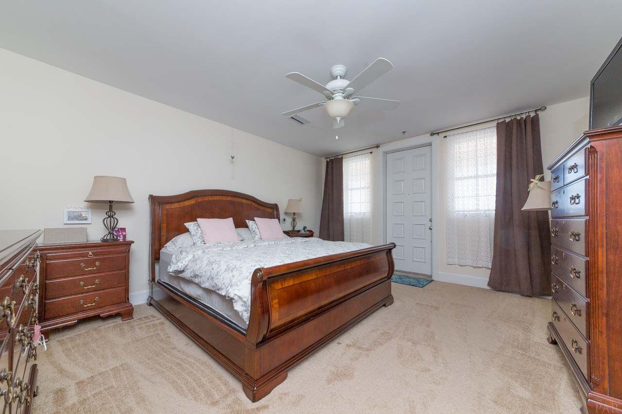 13928 River Road, Unit 504 Perdido Key, FL 32507 - Photo 16 of 40 a bedroom with a bed and a chandelier