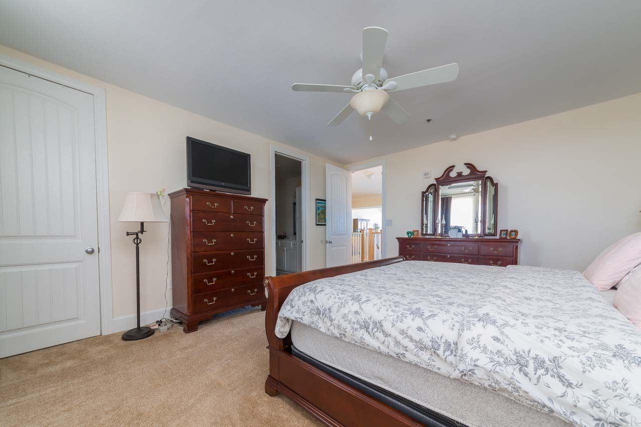 13928 River Road, Unit 504 Perdido Key, FL 32507 - Photo 17 of 40 a bedroom with a bed and a flat tv screen on dresser