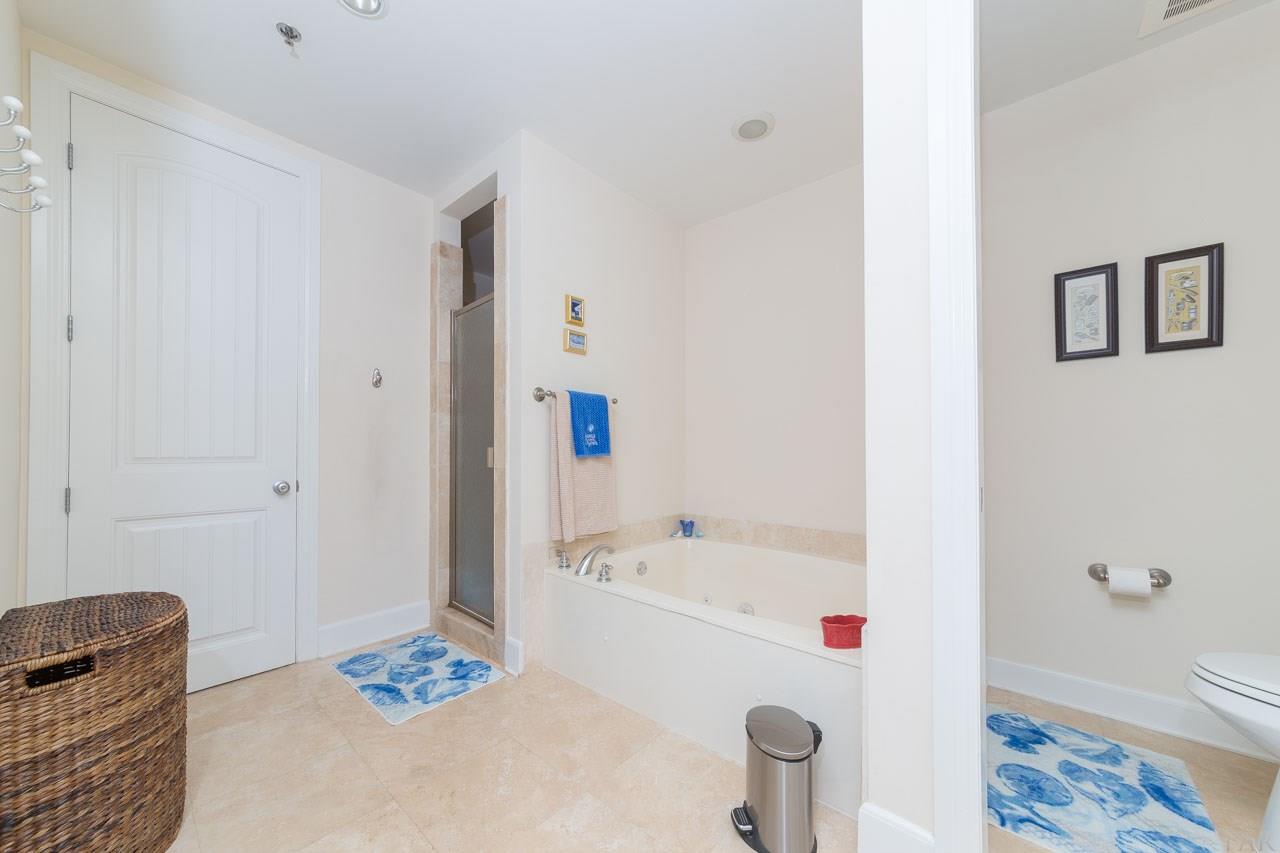 13928 River Road, Unit 504 Perdido Key, FL 32507 - Photo 18 of 40 a bathroom with a tub and a shower