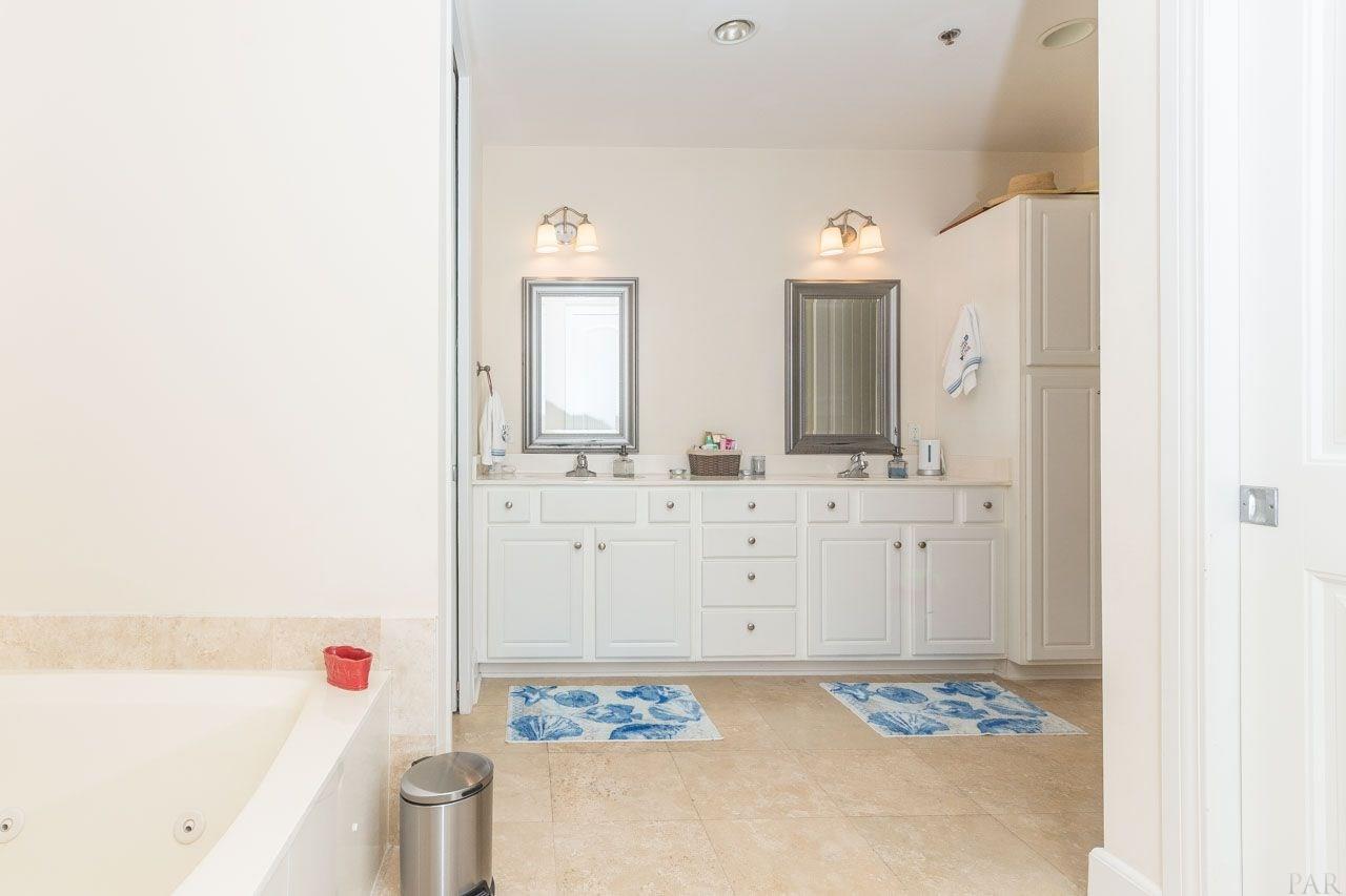 13928 River Road, Unit 504 Perdido Key, FL 32507 - Photo 19 of 40 a bathroom with a sink and a mirror