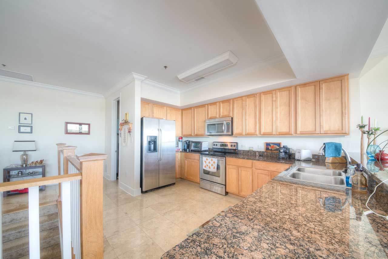 13928 River Road, Unit 504 Perdido Key, FL 32507 - Photo 2 of 40 a kitchen with stainless steel appliances granite countertop a refrigerator sink and stove